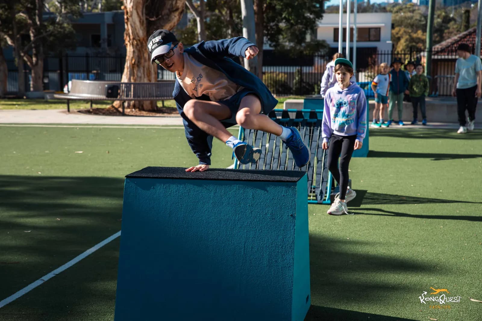 A coach demonstrating a vault over a Playkour box at a pop-up session